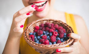 women eating berries